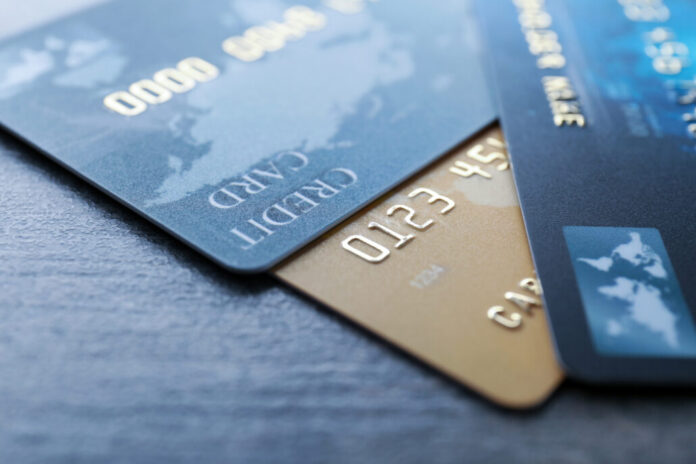 Different credit cards on table, closeup Banco